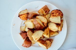 roasted potatoes with rosemary and garlic on a white plate