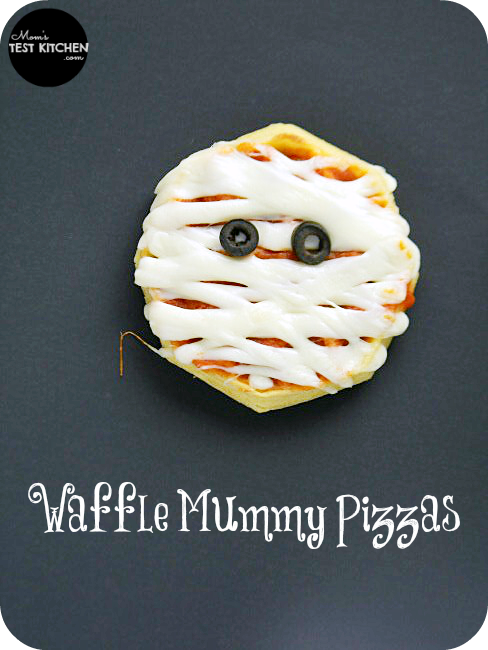 Eggo Waffles topped with pizza sauce, mozzarella cheese and black olives to make a Mummy Waffle Pizza face