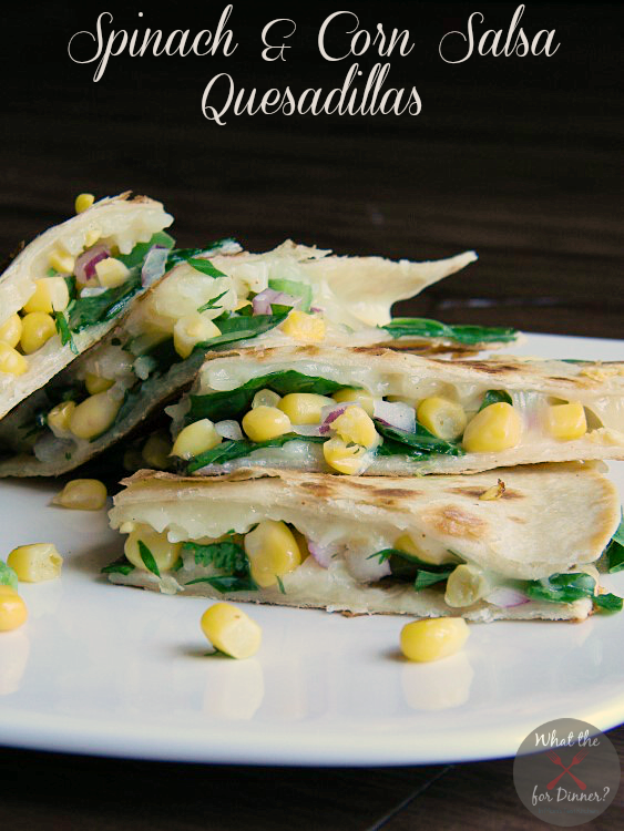 Veggie Quesadillas filled with spinach and corn salsa cut into triangles and stacked on a white plate