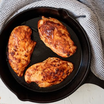 Three Chicken breasts in a cast iron skillet