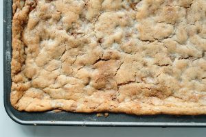 sugar cookie bars uncut on a baking dish