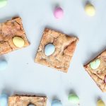 cookie bars on a white background surrounded by mini egg candies