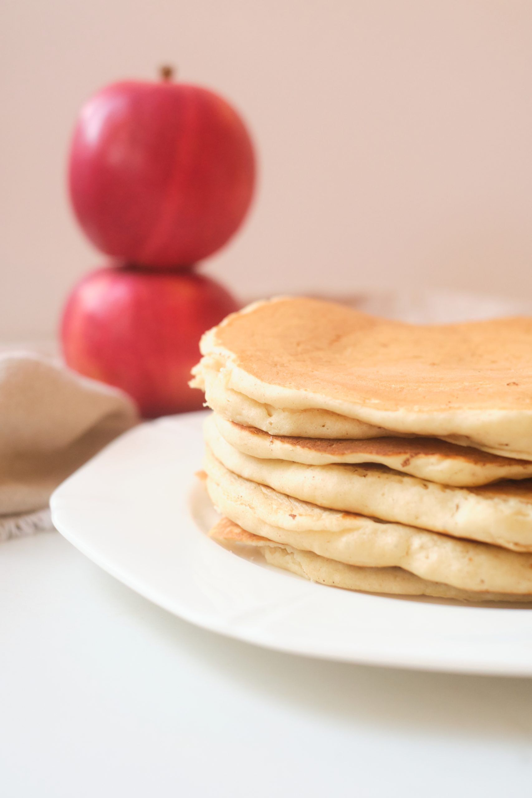 stack of 5 pancakes on a white plate, no toppings